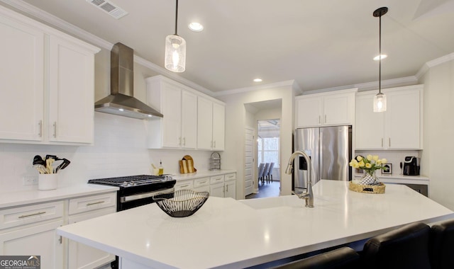 kitchen featuring stainless steel fridge with ice dispenser, a center island with sink, and wall chimney range hood