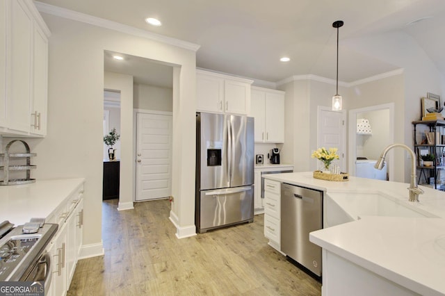 kitchen featuring decorative light fixtures, sink, light hardwood / wood-style flooring, stainless steel appliances, and white cabinets