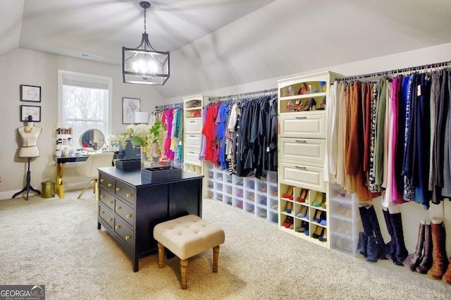 walk in closet with lofted ceiling and carpet flooring