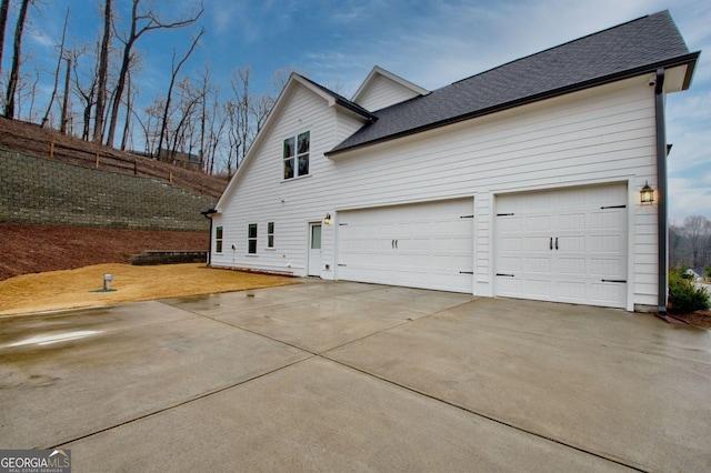 view of side of property featuring a garage