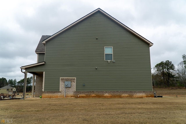 view of side of home featuring a lawn