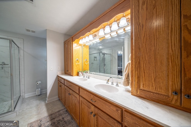 bathroom with a shower with shower door and vanity