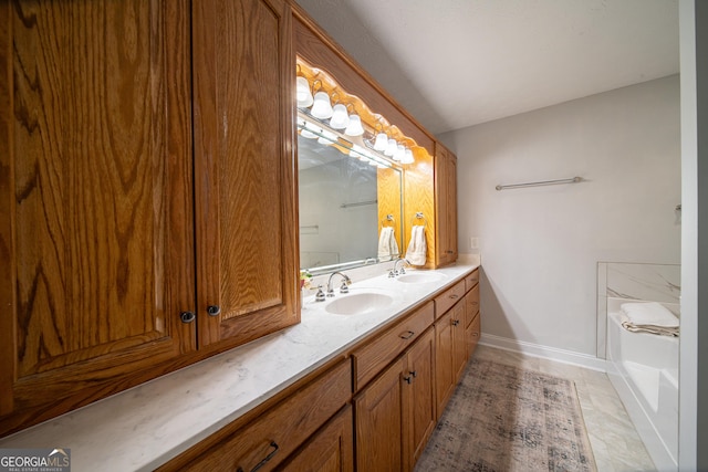 bathroom with tile patterned flooring, a tub, and vanity