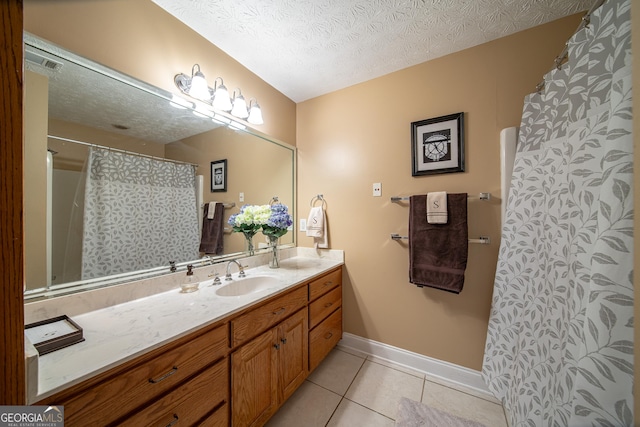 bathroom featuring a textured ceiling, vanity, a shower with shower curtain, and tile patterned flooring