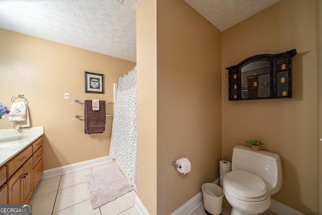 bathroom featuring a textured ceiling, toilet, vanity, and tile patterned flooring