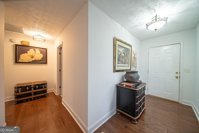 entryway featuring dark hardwood / wood-style flooring and a textured ceiling