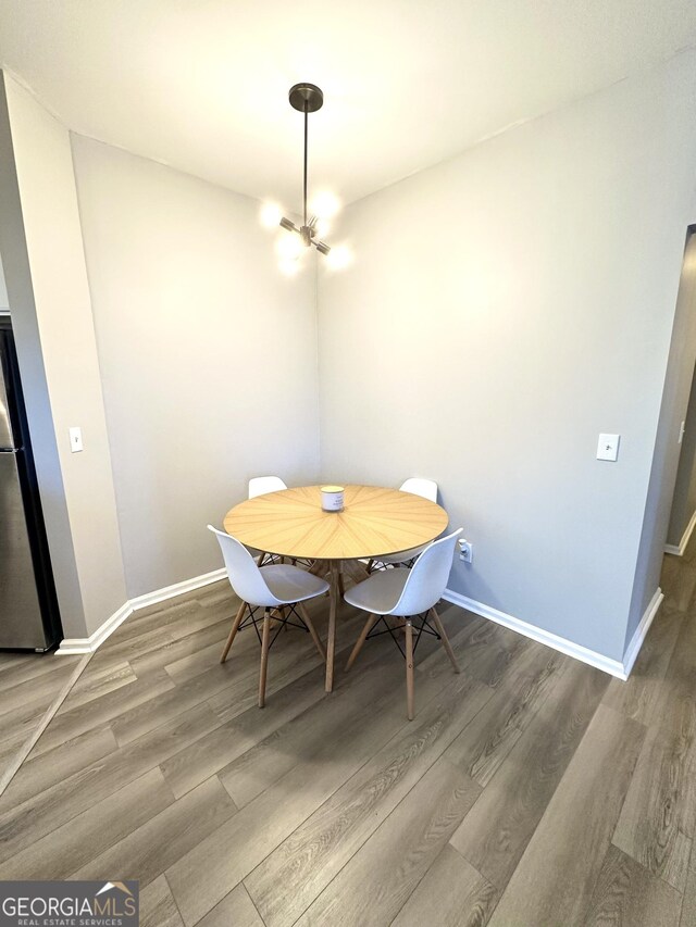 kitchen featuring stainless steel appliances, decorative backsplash, light hardwood / wood-style floors, and white cabinets