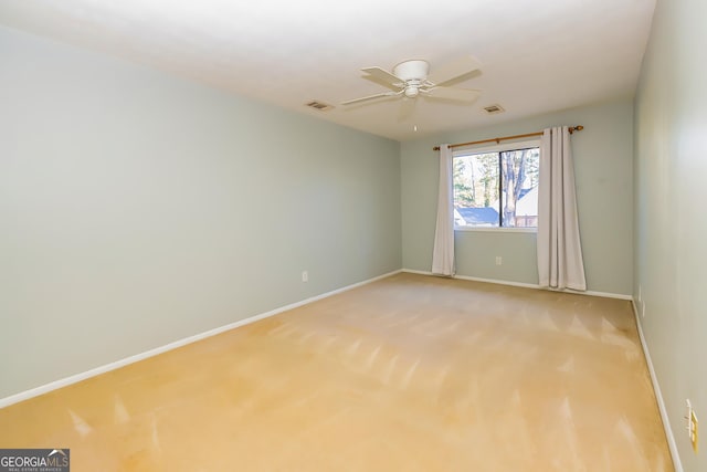 carpeted spare room with ceiling fan