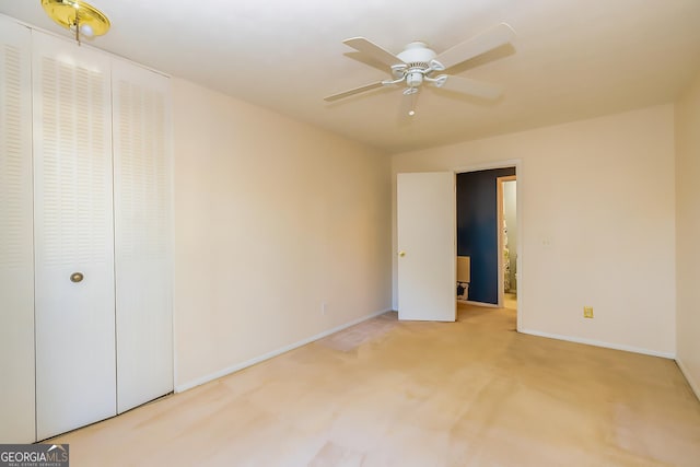 unfurnished bedroom with ceiling fan, a closet, and carpet floors