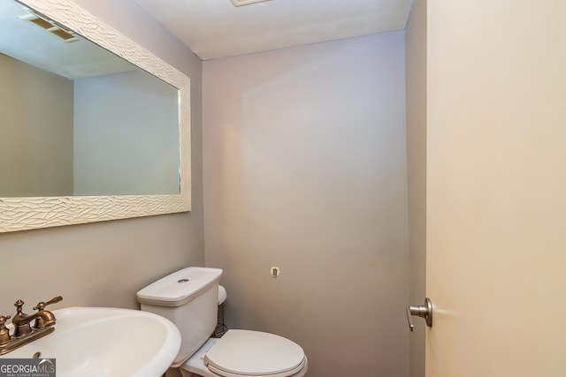 bathroom featuring toilet and sink