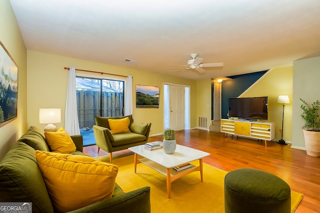 living room with ceiling fan and light wood-type flooring