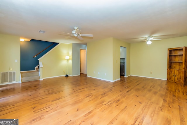 unfurnished living room featuring ceiling fan and light hardwood / wood-style floors