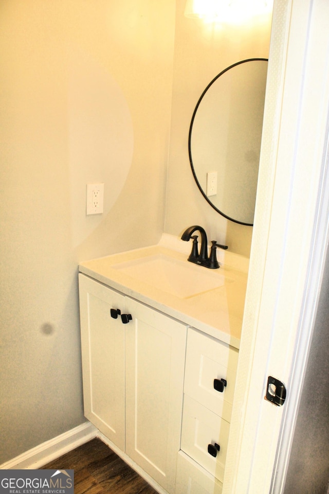 bathroom with vanity and hardwood / wood-style flooring