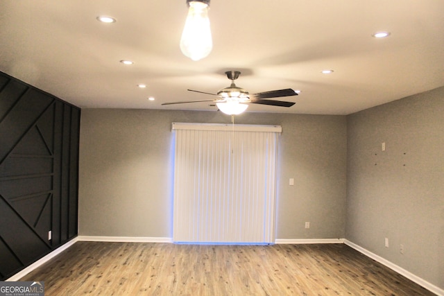 unfurnished room with ceiling fan and wood-type flooring