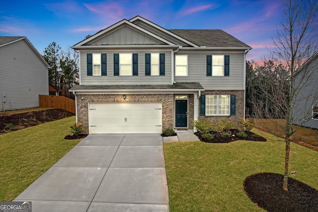 view of front of house featuring a garage and a lawn