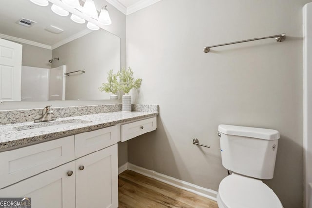 bathroom with vanity, a shower, toilet, ornamental molding, and hardwood / wood-style flooring