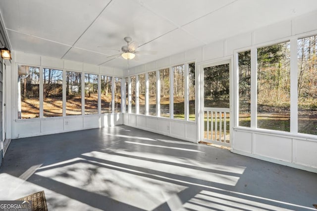 unfurnished sunroom with ceiling fan