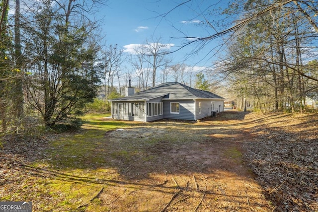 view of side of property featuring a sunroom