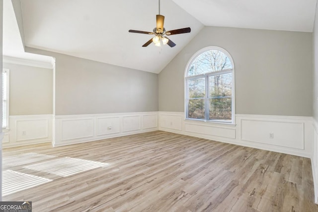 empty room featuring light hardwood / wood-style floors, ceiling fan, and vaulted ceiling