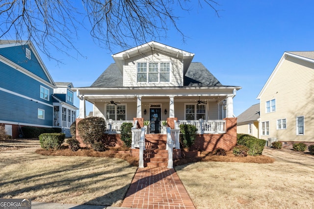 bungalow-style home with ceiling fan, a porch, and a front lawn