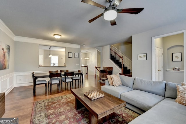 living room featuring ceiling fan, crown molding, and hardwood / wood-style floors