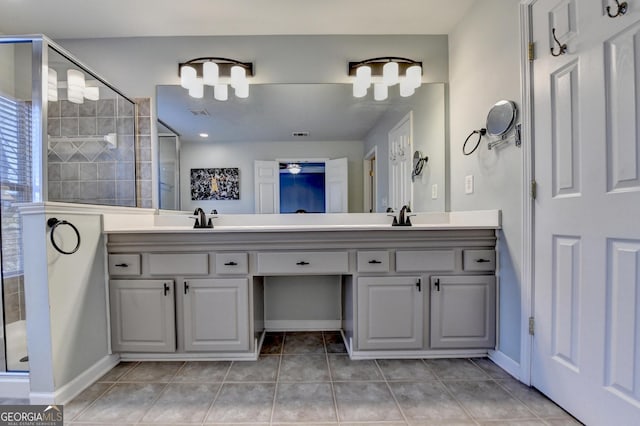 bathroom with an enclosed shower, vanity, and tile patterned flooring