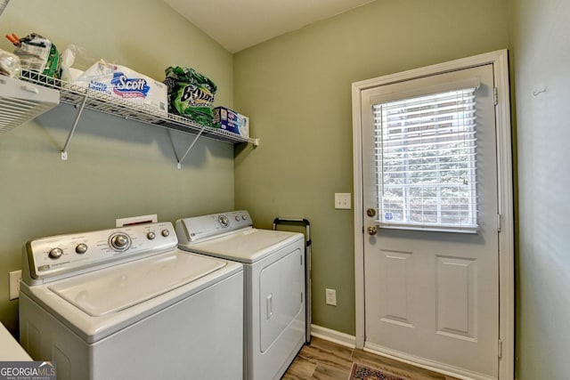 washroom with wood-type flooring and washer and clothes dryer