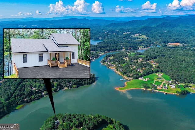 aerial view featuring a water and mountain view