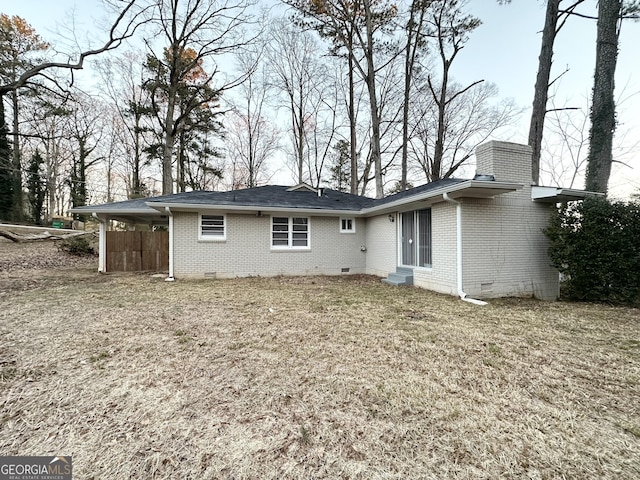 rear view of house with a lawn