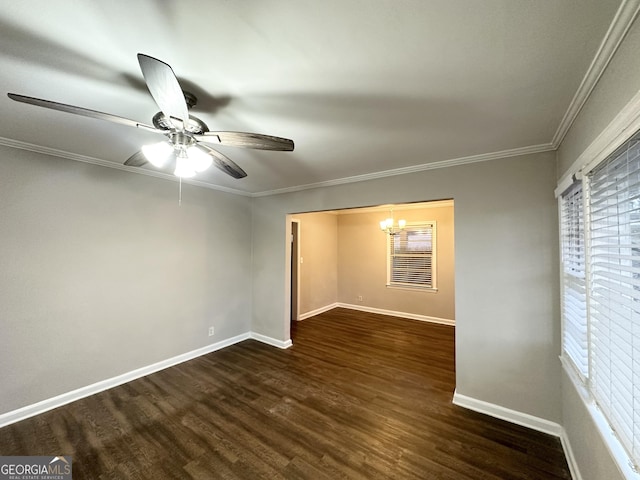 unfurnished room with dark hardwood / wood-style flooring, ceiling fan with notable chandelier, and ornamental molding