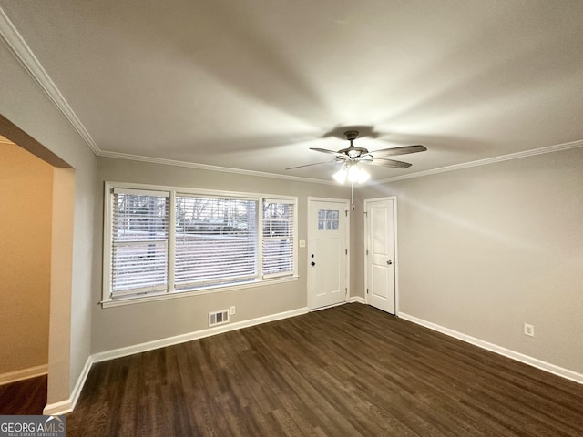 spare room featuring ceiling fan, dark hardwood / wood-style flooring, and ornamental molding