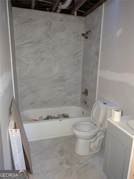 full bathroom featuring toilet, tiled shower / bath, and vanity