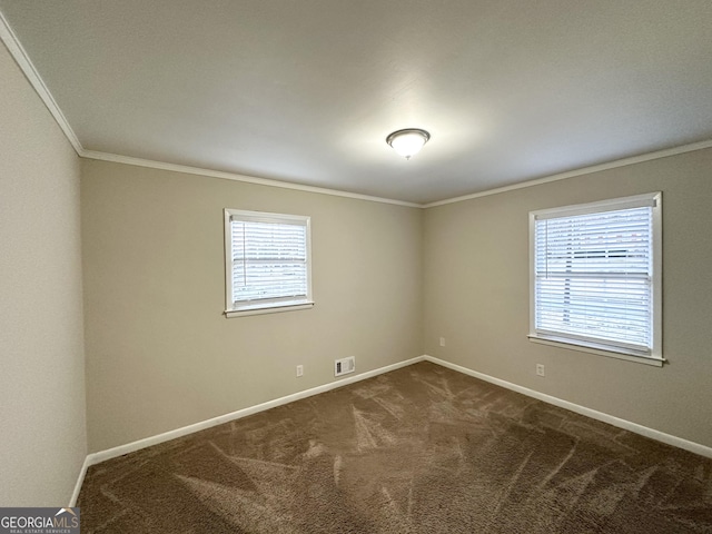 carpeted spare room featuring crown molding