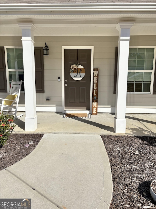 doorway to property featuring a porch