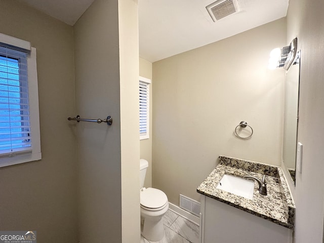 bathroom featuring toilet and vanity