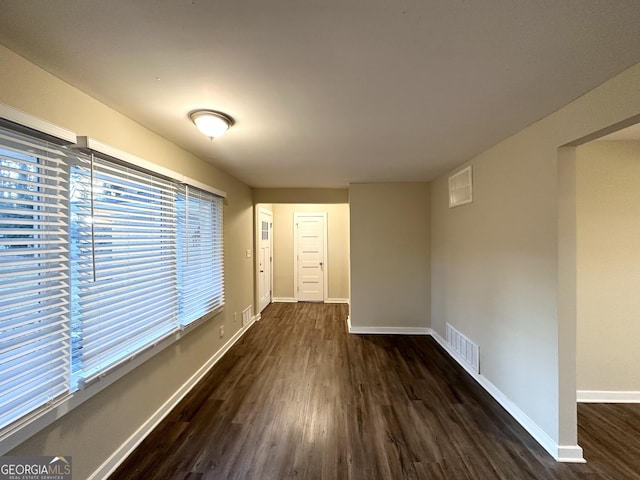 corridor with dark hardwood / wood-style floors