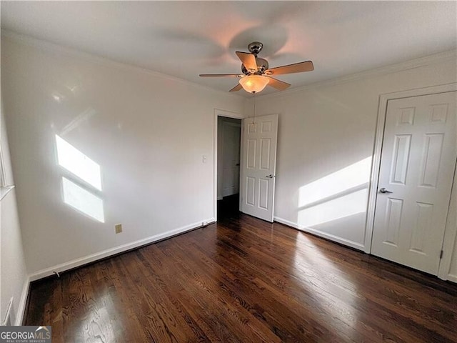 unfurnished bedroom featuring dark wood-type flooring, ceiling fan, and ornamental molding