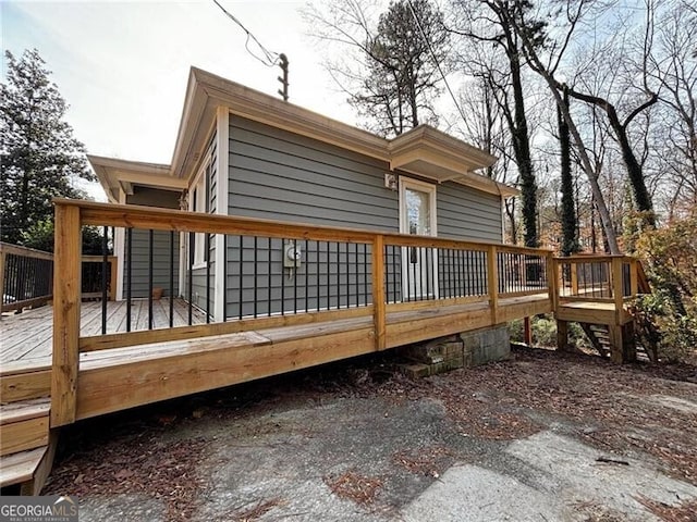 back of house with a wooden deck