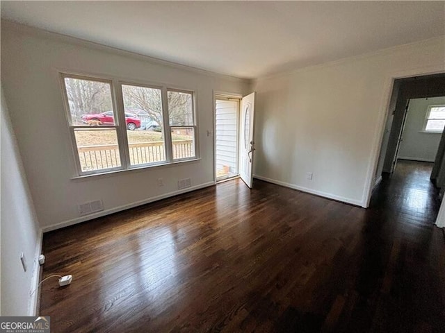 spare room with crown molding and dark hardwood / wood-style floors