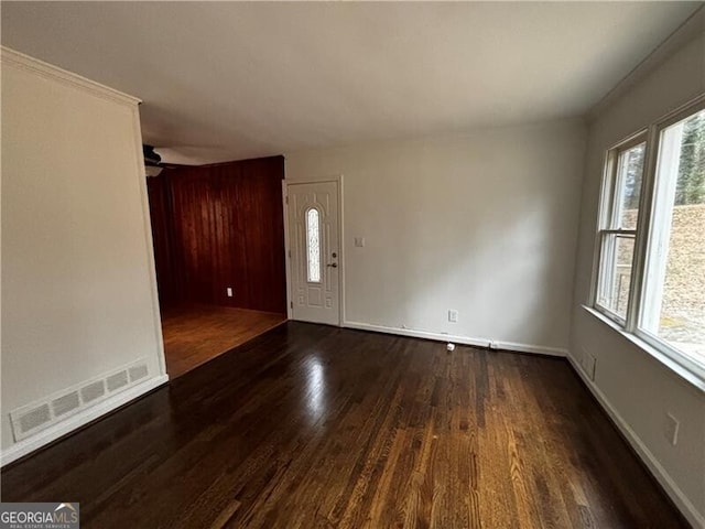 empty room featuring ceiling fan and dark wood-type flooring