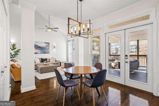 dining area featuring decorative columns, ceiling fan, dark hardwood / wood-style floors, lofted ceiling, and french doors