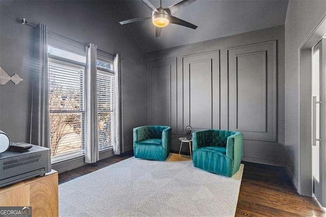 sitting room featuring dark wood-type flooring and ceiling fan