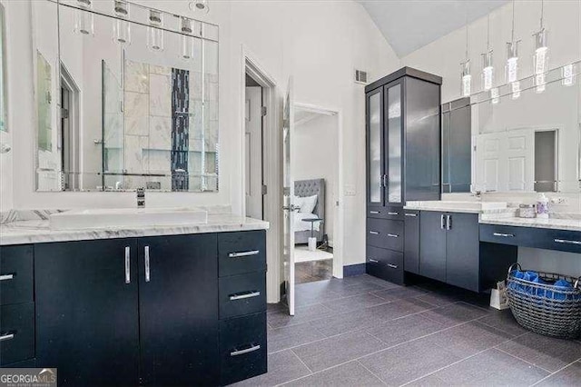 bathroom with high vaulted ceiling and vanity