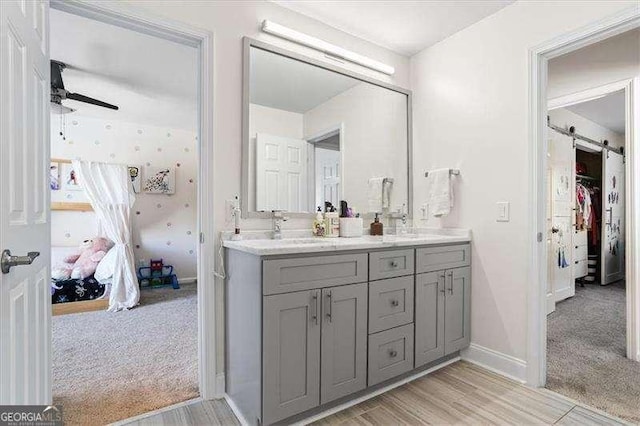 bathroom with ceiling fan and vanity