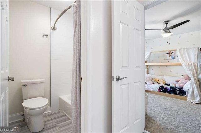 bathroom with toilet, ceiling fan, shower / washtub combination, and hardwood / wood-style flooring