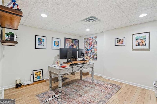 office featuring a drop ceiling and wood-type flooring