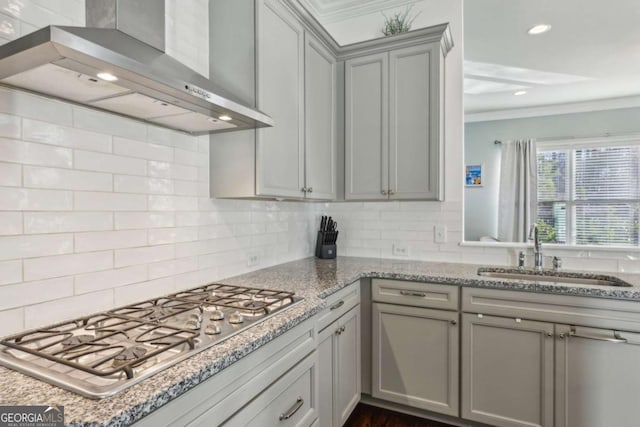 kitchen featuring sink, stainless steel gas cooktop, gray cabinetry, and wall chimney exhaust hood