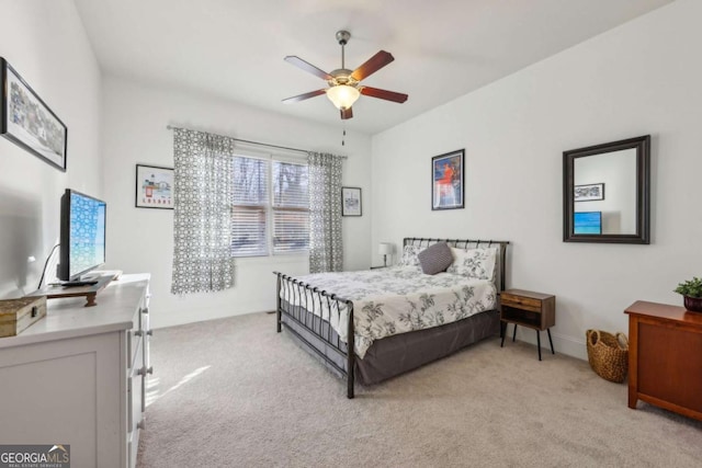 bedroom featuring ceiling fan and light carpet