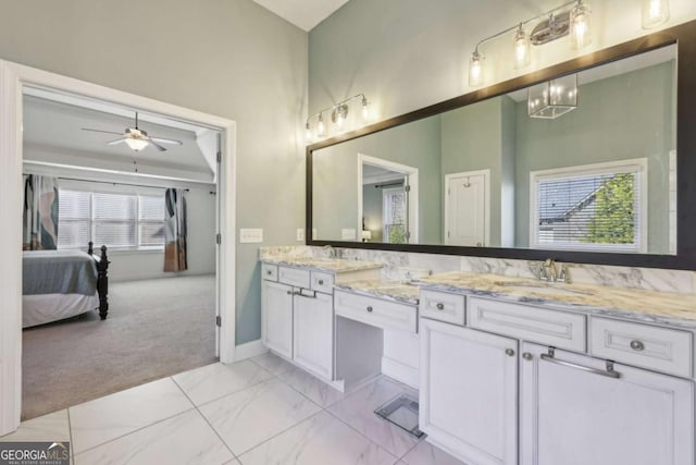 bathroom featuring vanity and ceiling fan with notable chandelier