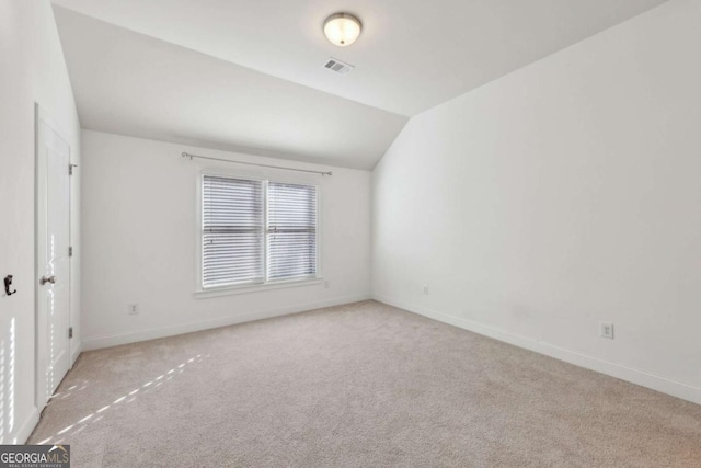 interior space with light carpet and lofted ceiling